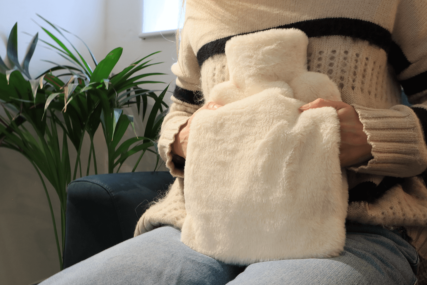 Pouchy-Faux-Fur-Hot-Water-Bottle-in-white-lifestyle-hands