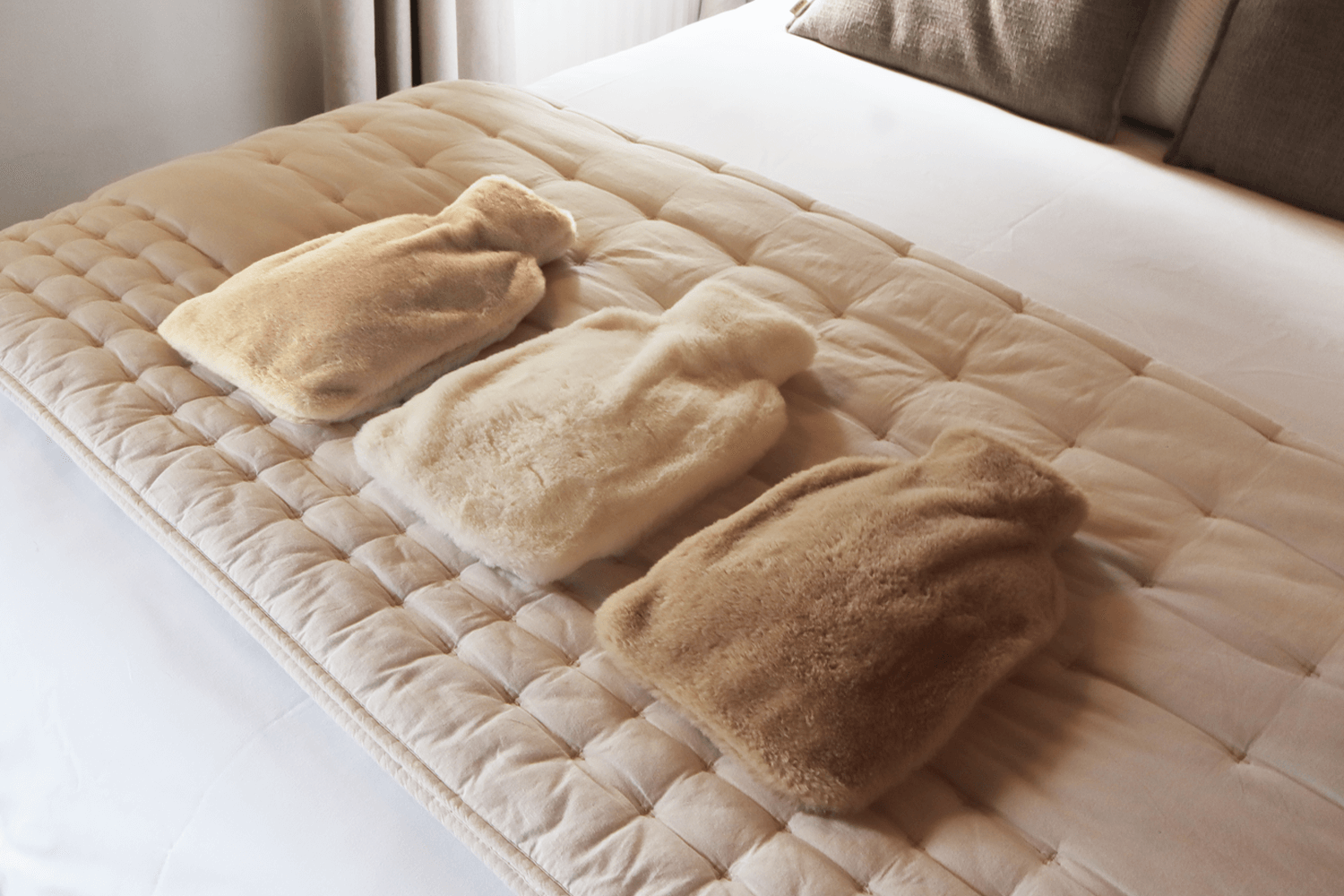 Pouchy-Faux-Fur-Hot-Water-Bottles-on-bed